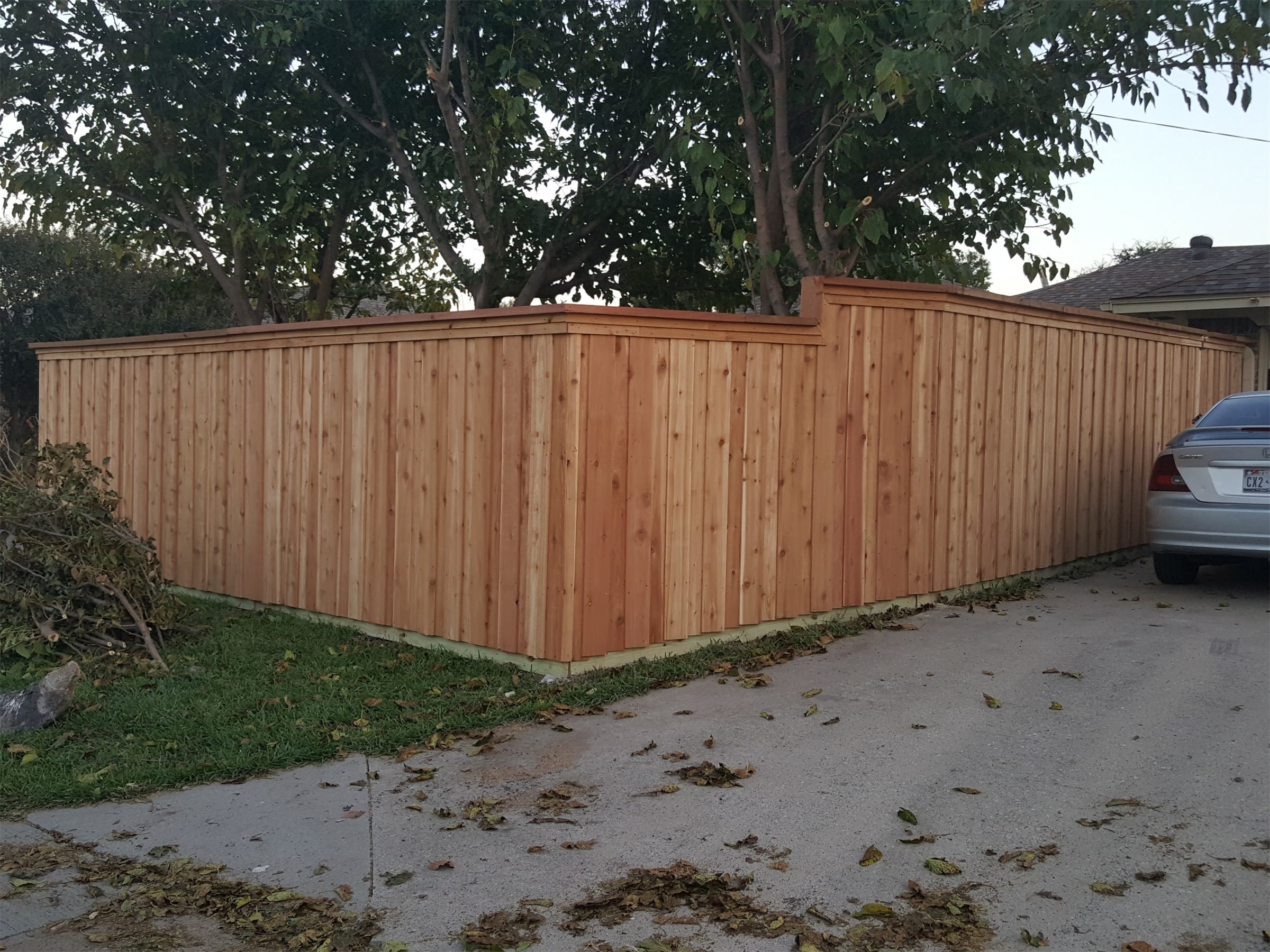 Cedar privacy fence along a driveway