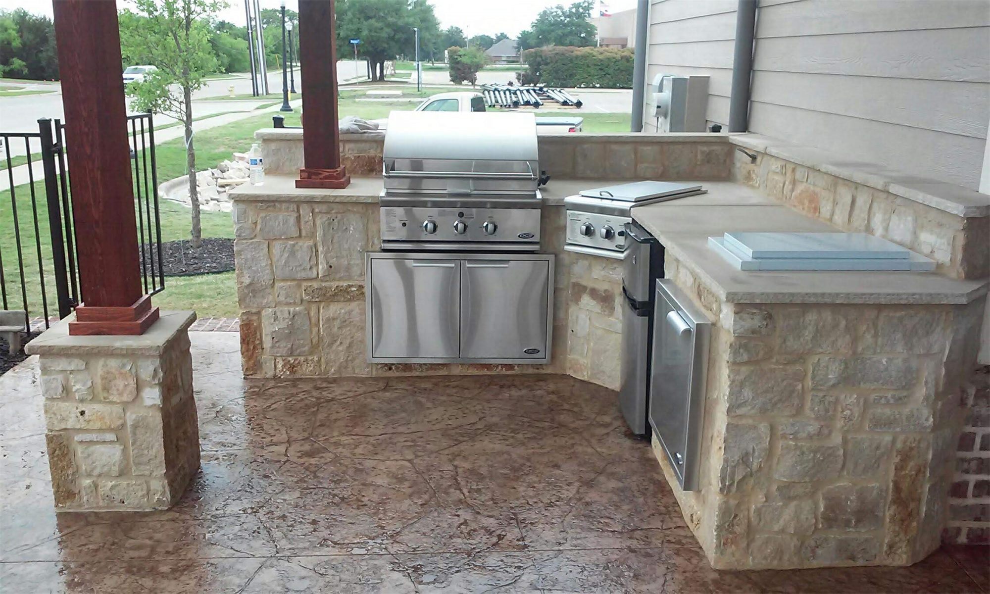 Stone outdoor kitchen with built-in grill